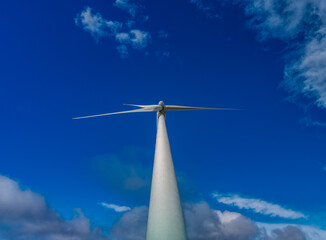 Modern windmill bottom view against blue sky