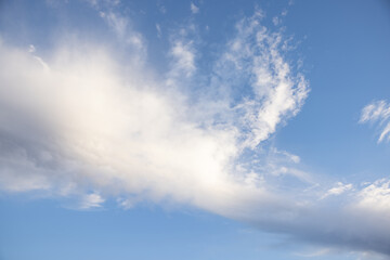 Fototapeta premium Amazing clouds hanging in the blue sky. Wonderful sunset and a better sunrise with beautiful clouds with a colorful sky.