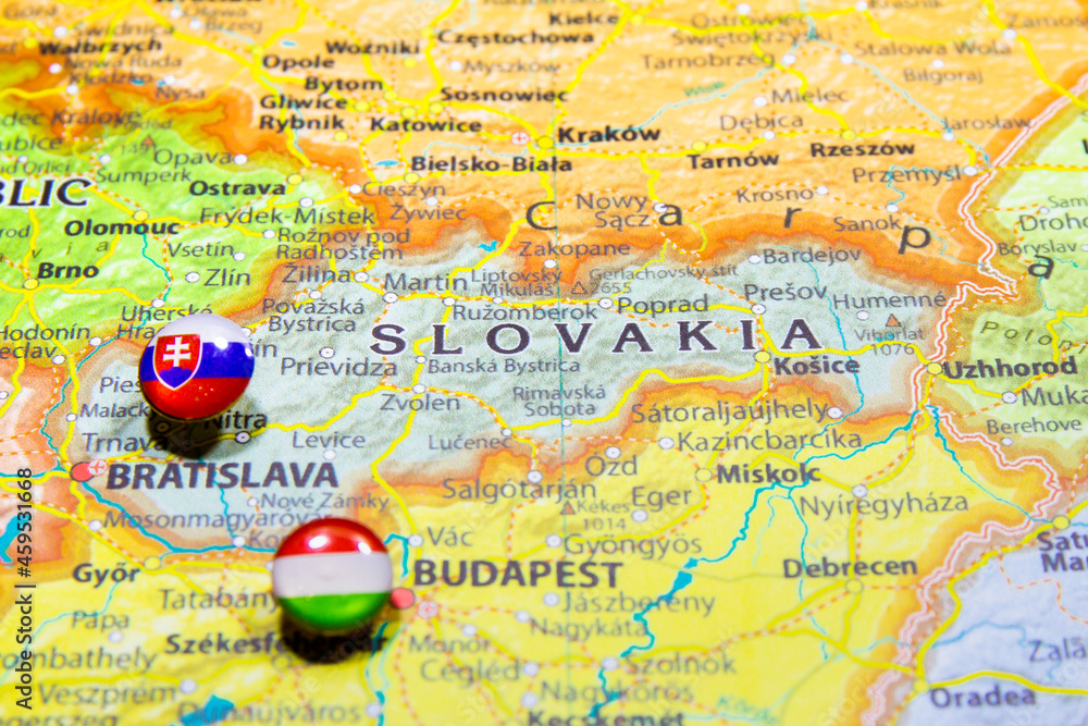 Wall mural National flag Slovakia pinned on political Europe map. Macro Close up picture on a colorful and blurry world atlas. Capital country - Bratislava. Push pin marker of destination. - Wall murals