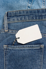 Empty price tag in the pocket of jeans. Jeans with label. Sale concept