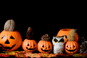 Halloween human skull, Halloween Pumpkins on an old wooden table in front of black background with free space for text.