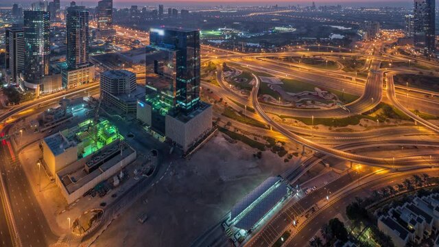 Aerial view of media city and al barsha heights district area night to day timelapse from Dubai marina.