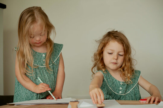 Twin girls with Down Syndrome drawing