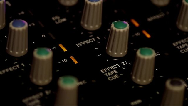 Led level indicator lights up. Portative cassette tape studio mixer closeup shot.
