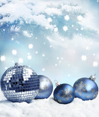 Beautiful blue Christmas balls on snow on winter background.