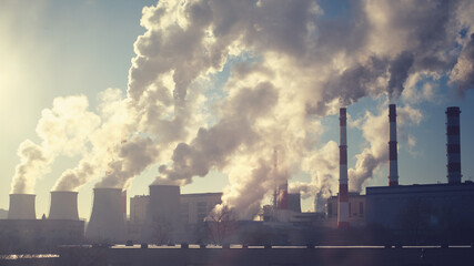 Smoke from industrial pipes on a clear sunny day, smog from factory waste