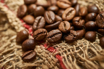 Roasted coffee beans on piece of sackcloth