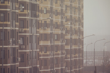 Windows on the facades of high-rise apartment buildings, fog close-up