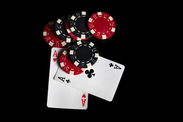 Poker game with one pair combination. Chips and cards on the black table in poker club. Free advertising space