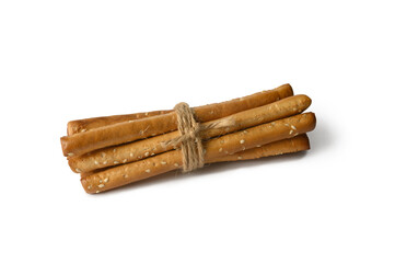 Grissini lie on a white background. Crispy white sticks. With sesame seeds. The appetizer is delicious.