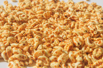 Oatmeal puffed with honey for a healthy nutritous breakfast - detail pile