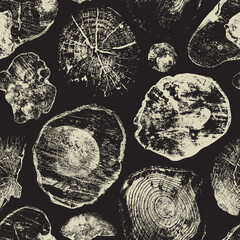 Abstract seamless pattern with old wood saw cuts on a black backdrop. Wooden texture with annual rings and cross sections of old trees. Monochrome vector background with various shaped stumps - obrazy, fototapety, plakaty