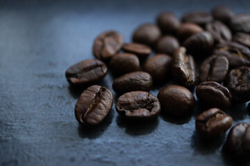 Coffee beans on a dark surface