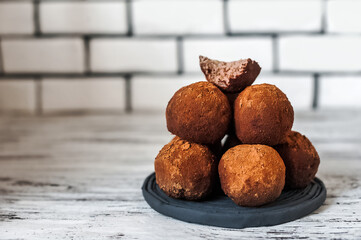 Homemade truffle candies in cocoa powder close-up and copy space...