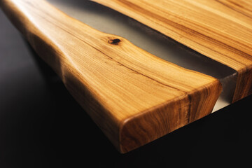 Style wooden countertop slab, saw cut wood treated with varnish close-up on black. Isolate. 