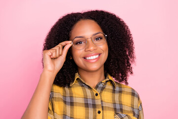 Photo of cheerful positive lady hold eyewear toothy smile wear plaid shirt isolated pink color background