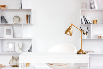 Modern fashionable freelance workplace with table, lamp, bookshelves. Minimalist style freelancer...