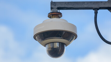Round CCTV camera against blue sky - 459545672