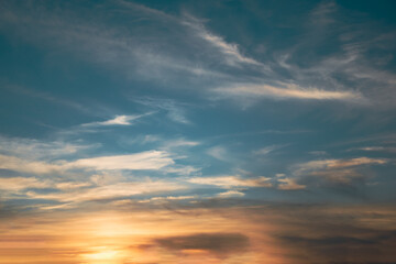 The sky with the setting sun, clouds, and birds.