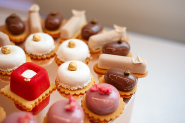 Sweet cakes at a wedding buffet. Catering