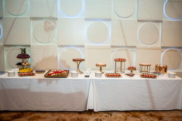 Sweet cakes at a wedding buffet. Catering