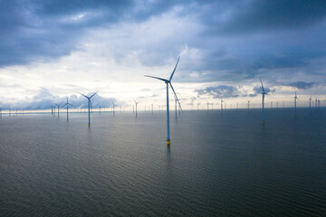 Aerial view, Enormous windmills stand in the sea along a dutch sea. Fryslân wind farm, the largest...