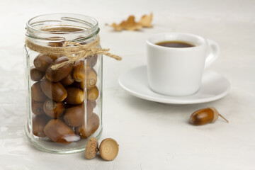 Acorns in a glass jar and acorn coffee. Healthy no caffeine beverage