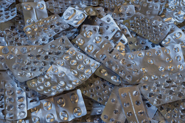 A large number of empty silver blisters from medical pills. Background. Texture.