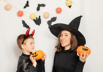 Child and mother in Halloween costume. Happy Family celebrating for Halloween