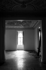 Light entering an abandoned and ruined house, in black and white 