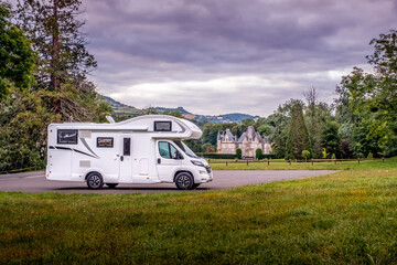 Motorhome parked in front of a small chateau (castle) in the Normandy department, France