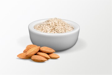 Almond flour in the bowl and almonds nut on the desk