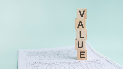 word Value with wood building blocks, light green background