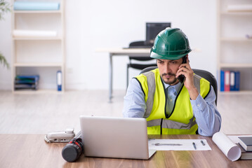 Young male architect working in the office