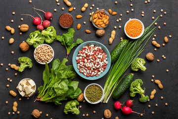  A source of protein for vegetarians: vegetables, nuts, seeds and legumes top view on a black...