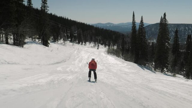 Grouped Skier Fast Slides On Skis On Snowy Mountainside Enjoying Sunny Winter
