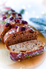 Christmas cake decorated with cranberries and powdered sugar