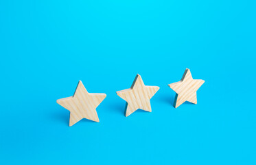 Three stars on a blue background. Rating evaluation concept. Service quality. Buyer feedback. High...