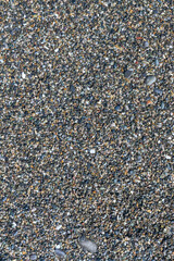 sea beach of small multi-colored pebbles as a natural background
