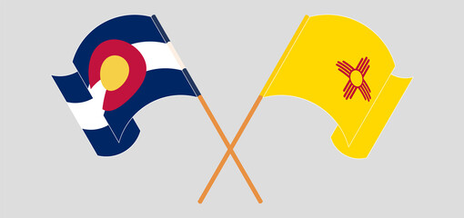 Crossed and waving flags of The State of Colorado and the State of New Mexico