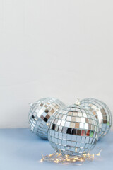 Disco ball against white and light blue background with empty space for text 