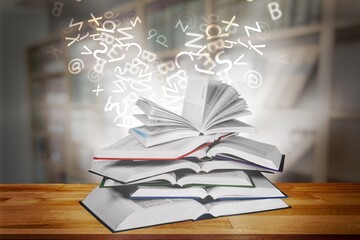 Old book with flying letters and magic light in library. Knowledge, history, memory and information.