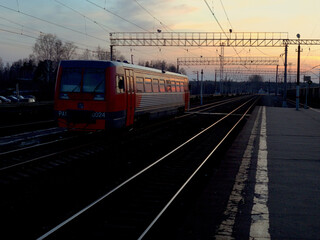 Fototapeta na wymiar Last evening train at the far station. Long distance trains. Russia, Moscow region.