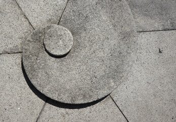 Closeup shot of a stone surface with a nautilus shell shape