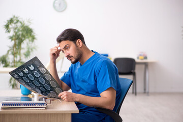 Young male doctor radiologist sitting in the clinic