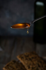 Honey in a teaspoon on a blurred background