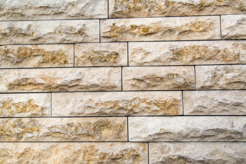 The background of the wall is made of strips of natural dolomite of gray color with a beautiful stone pattern. Backgrounds texture design.