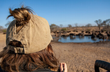 Woman looking at a watering hole in South Africa