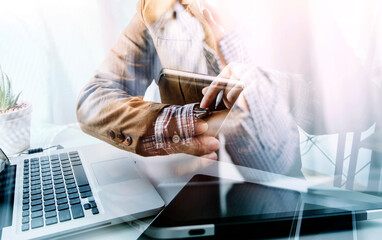 businesswoman hand working with laptop computer, tablet and smart phone in modern office with virtual icon diagram at modernoffice in morning light