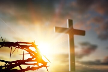 Crown of thorns of Jesus Christ against wooden catholic cross at outdoor background
